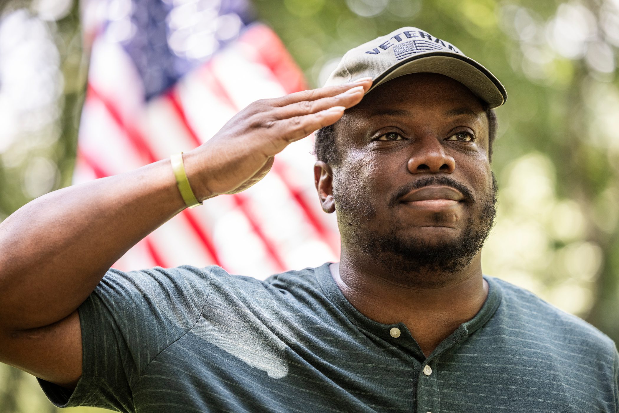 Man saluting by the flag.